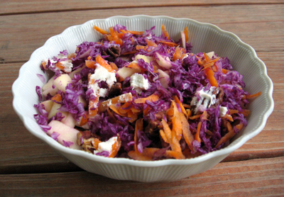 Breakfast.  Purple cabbage mixed with carrot, apple, pecans and goat cheese.